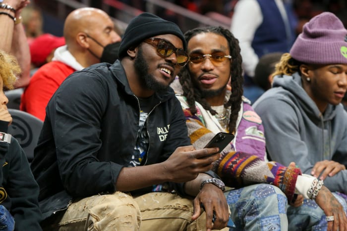 Mar 13, 2022; Atlanta, Georgia, USA; Cleveland Browns safety Richard LeCounte talks to rapper Quavo during a game between the Atlanta Hawks and Indiana Pacers in the second quarter at State Farm Arena.